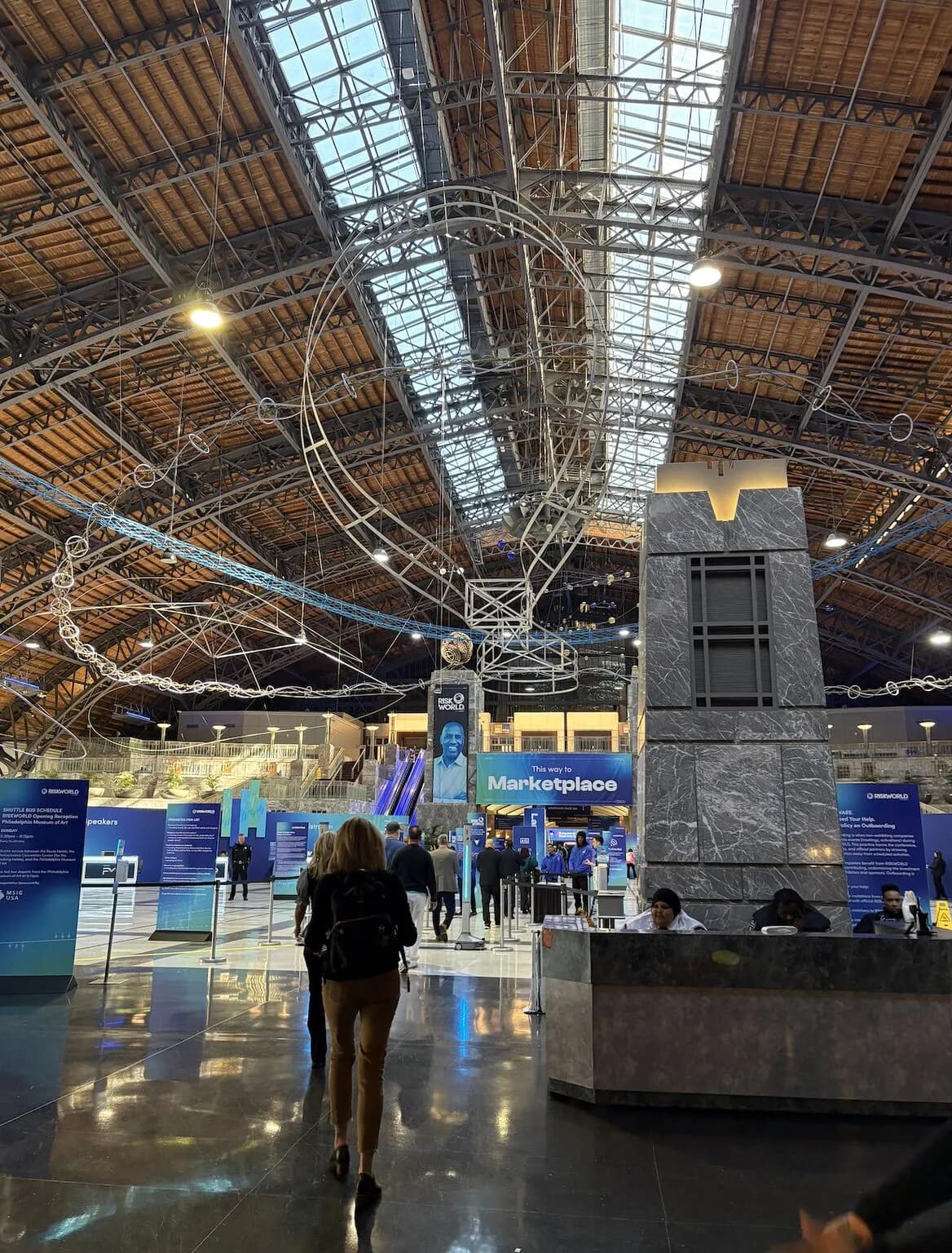 The conference hall entrance with signs pointing to the Marketplace